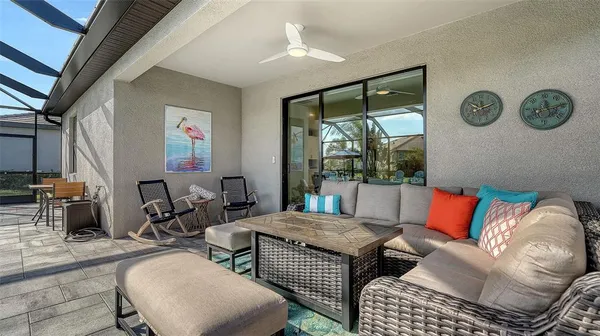 a front view of multi story residential apartment building with yard and outdoor seating