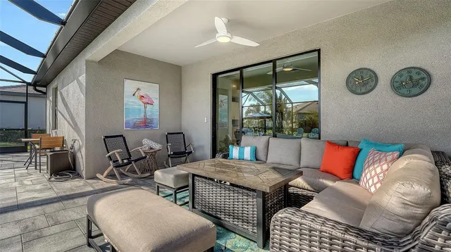 a front view of multi story residential apartment building with yard and outdoor seating