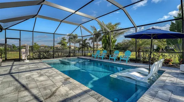 an aerial view of a house with a swimming pool yard and outdoor seating