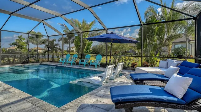a living room with furniture a flat screen tv and a large window