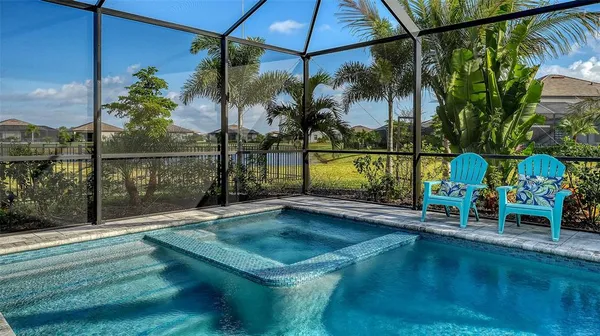 a living room with furniture a flat screen tv and a large window