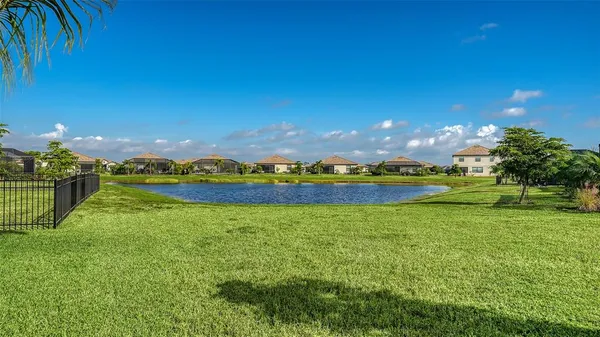 a view of a tennis ground with a large swimming pool