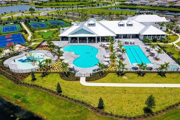 a view of a swimming pool with an outdoor seating and a yard
