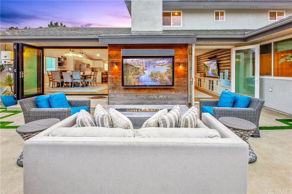 720 Sandpiper Drive Seal Beach, CA 90740 - Photo 2 of 69 The living room and the dining space opens up to the backyard.