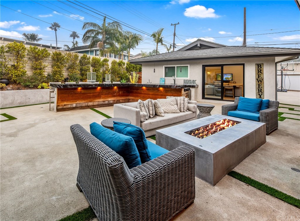 720 Sandpiper Drive Seal Beach, CA 90740 - Photo 11 of 69 Seating for 12, at the two sided bar. The perfect balance of rough wood, elegant granite, under-bar lighting, and stainless built-ins. The very best gathering spot!