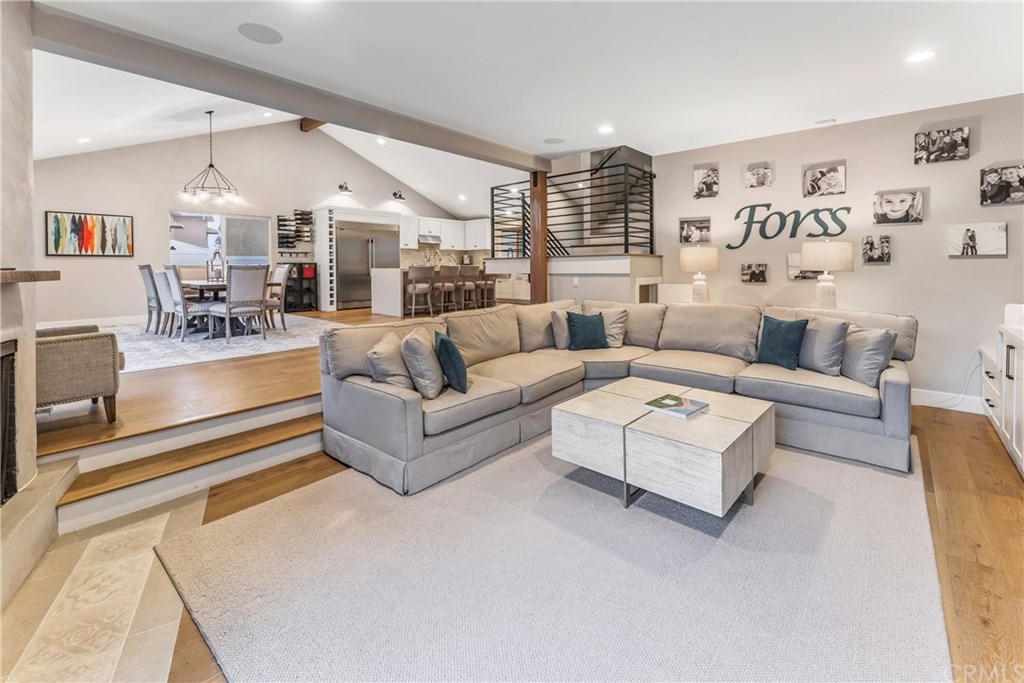 720 Sandpiper Drive Seal Beach, CA 90740 - Photo 12 of 69 The living room is set apart by two steps, and a beautiful fireplace. Built-in cabinets with the perfect accent wall create an inviting space.