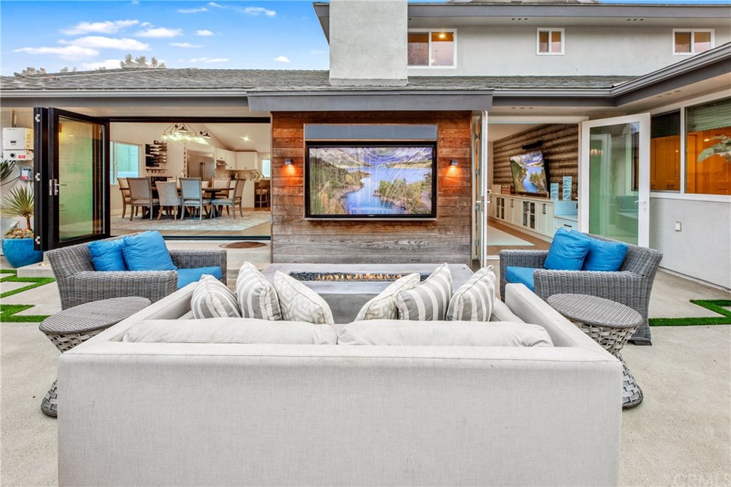 720 Sandpiper Drive Seal Beach, CA 90740 - Photo 38 of 69 The perfect spot! Cozy up to the fireplace for the Sunday Game. The ultimate entertainers backyard. Complete with TV, Firepit, Bar, BBQ and beautiful hardscape.