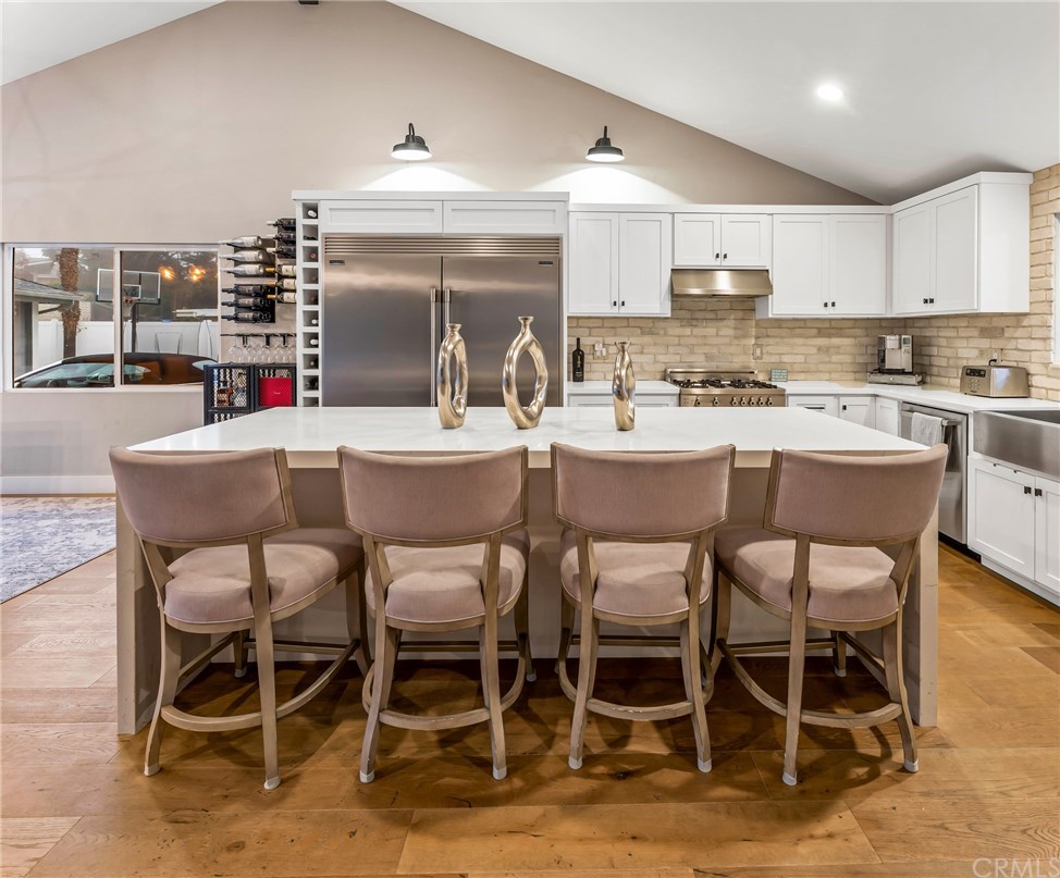 720 Sandpiper Drive Seal Beach, CA 90740 - Photo 47 of 69 Kitchen island seats four. Formal dining adjacent.