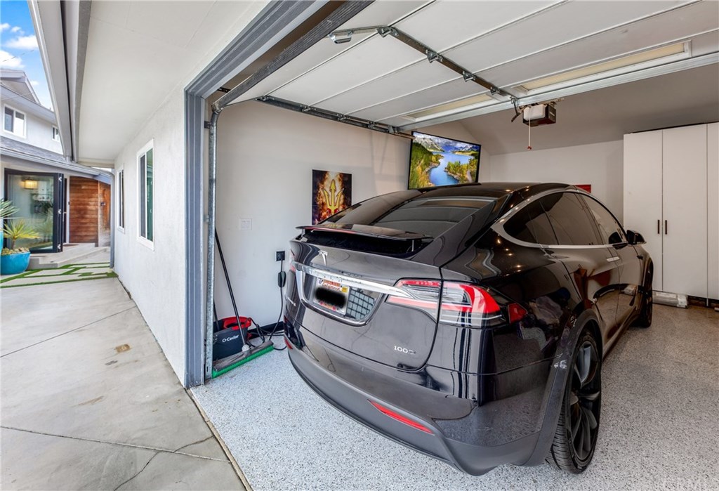 720 Sandpiper Drive Seal Beach, CA 90740 - Photo 64 of 69 Garage has finished floors, built in storage and a TV.