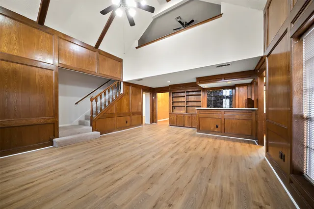 a view of a kitchen with wooden floor and electronic appliances