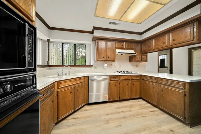 a kitchen with stainless steel appliances granite countertop a stove sink and cabinets