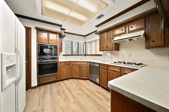 a kitchen with stainless steel appliances granite countertop a stove and a sink