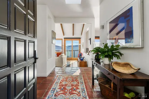 a living room with furniture large windows and a flat screen tv