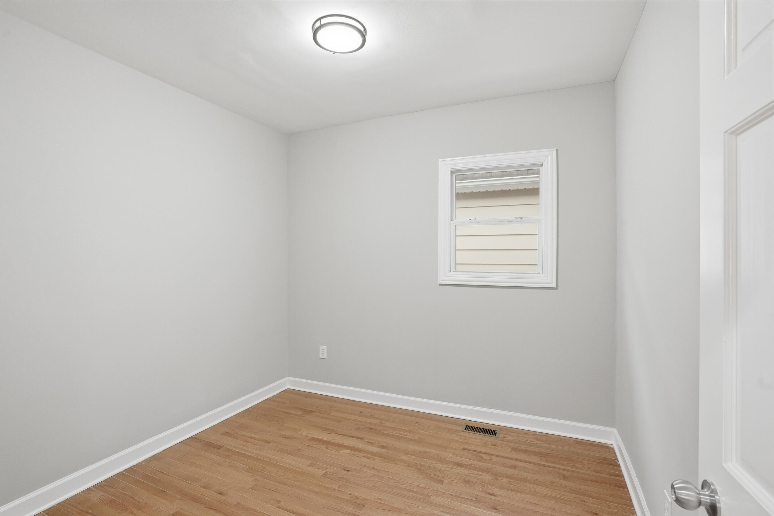 2406 Birch Avenue Whiting, IN 46394 - Photo 13 of 16 a view of an empty room with wooden floor and a window