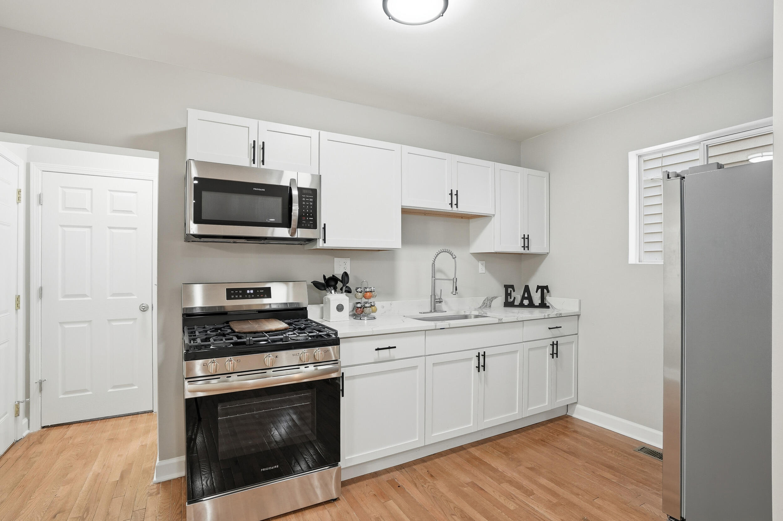 2406 Birch Avenue Whiting, IN 46394 - Photo 7 of 16 a kitchen with stainless steel appliances a stove a sink and a microwave
