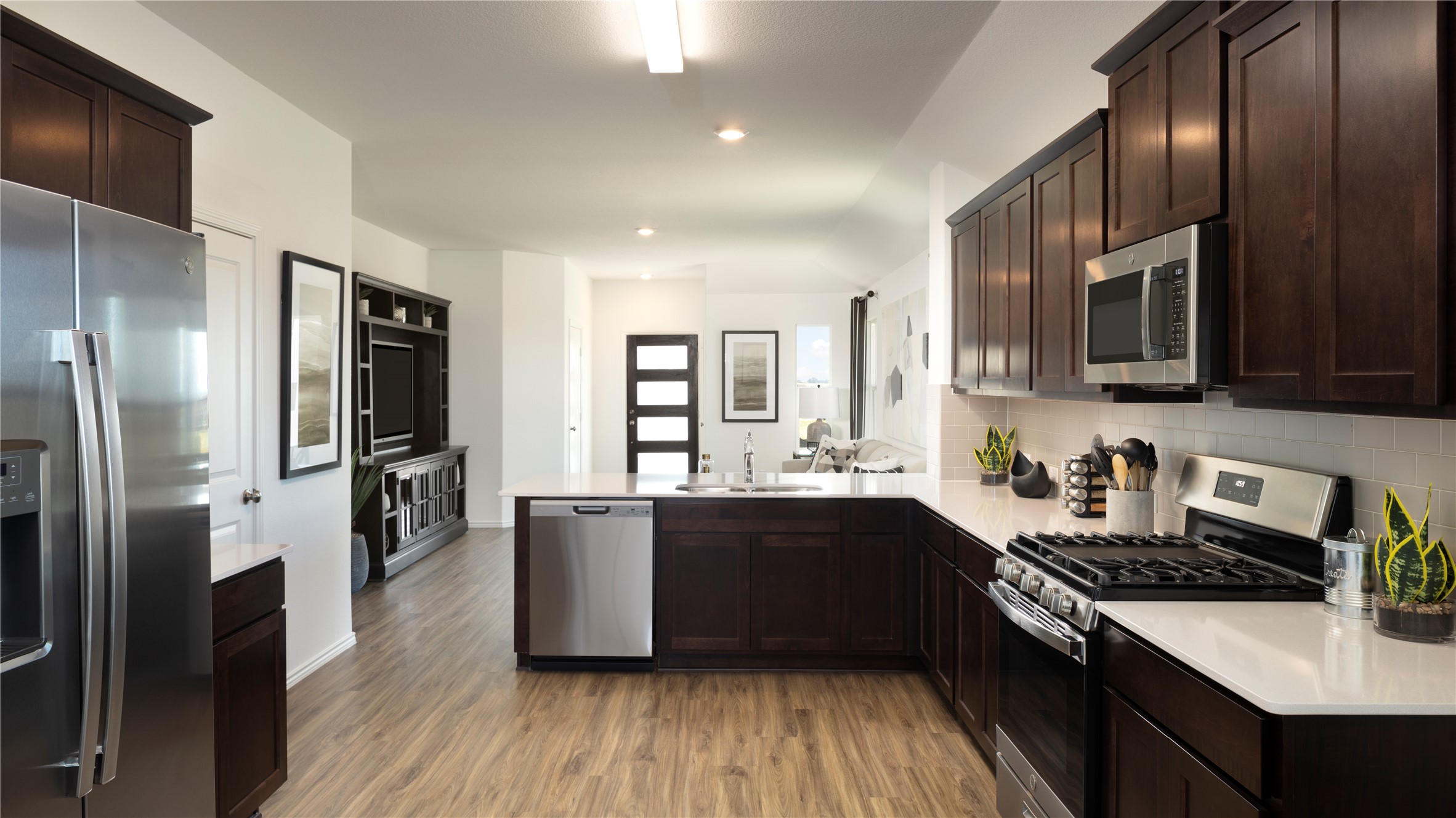 121 Sapling Dew Drive Georgetown, TX 78628 - Photo 14 of 14 a kitchen with stainless steel appliances granite countertop a stove a sink and a refrigerator