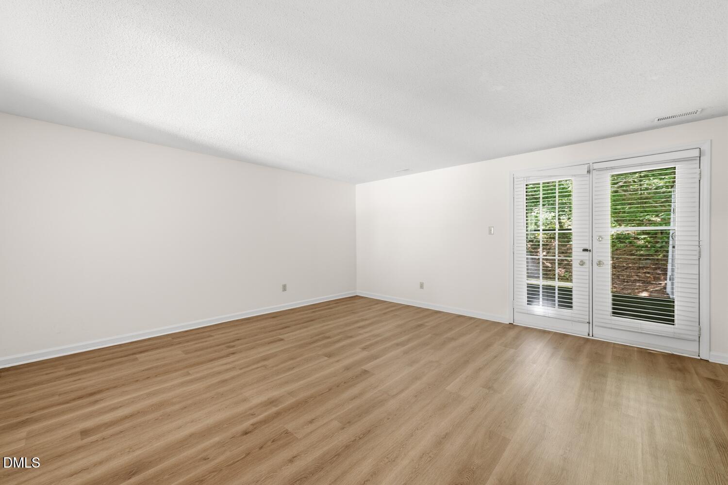 1135 Villa Green Court Raleigh, NC 27612 - Photo 10 of 17 a view of an empty room with wooden floor and a window