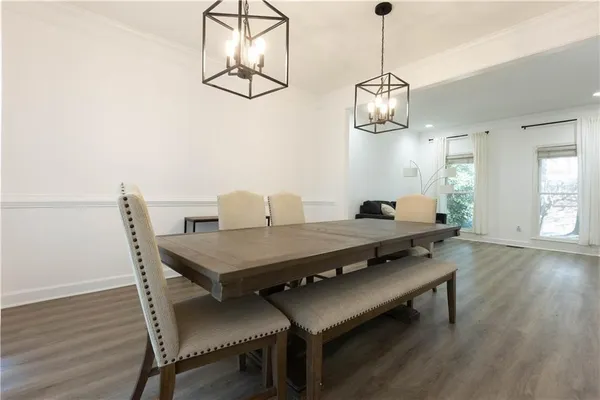 a view of a dining room with furniture wooden floor and chandelier