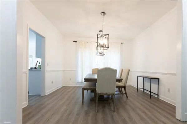 a view of a dining room with furniture and wooden floor