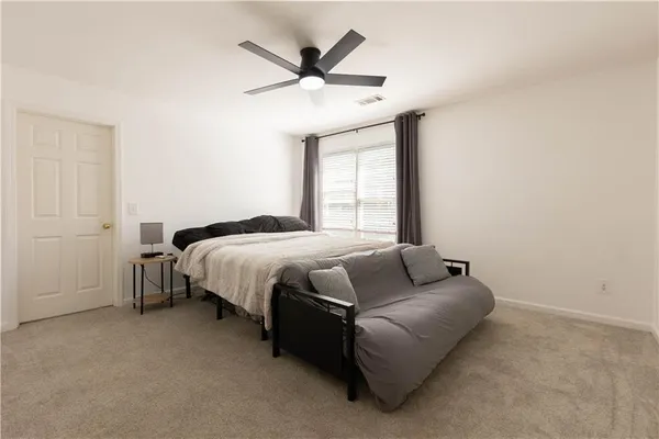 a bed sitting in a bedroom next to a window