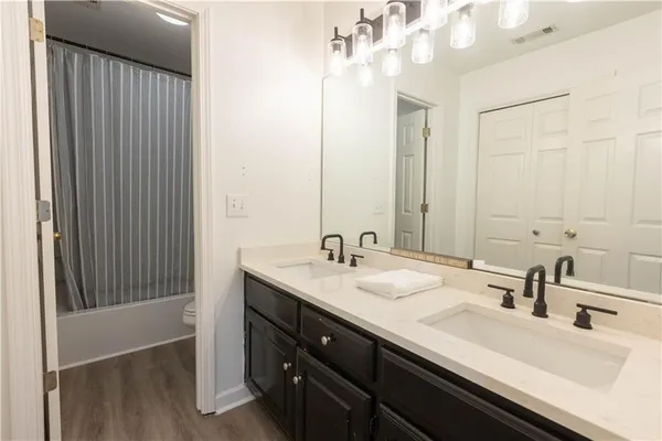 a bathroom with a sink double vanity and a mirror