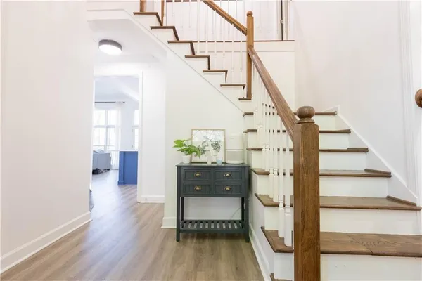 a view of entryway and hall with wooden floor