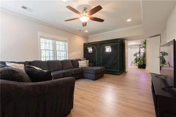a living room with furniture and a wooden floor