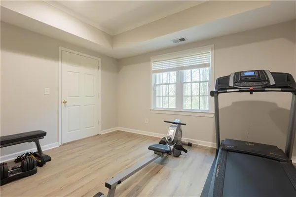 a view of a workspace with furniture and a window