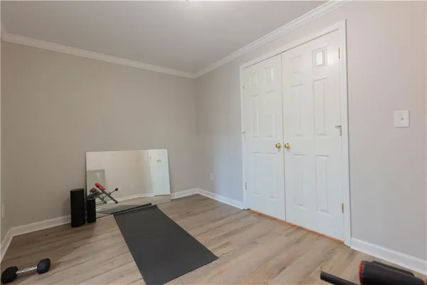 a view of a room with wooden floor and closet