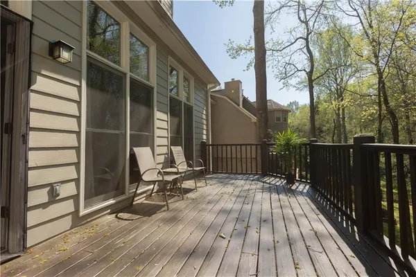 a view of balcony with wooden floor and fence