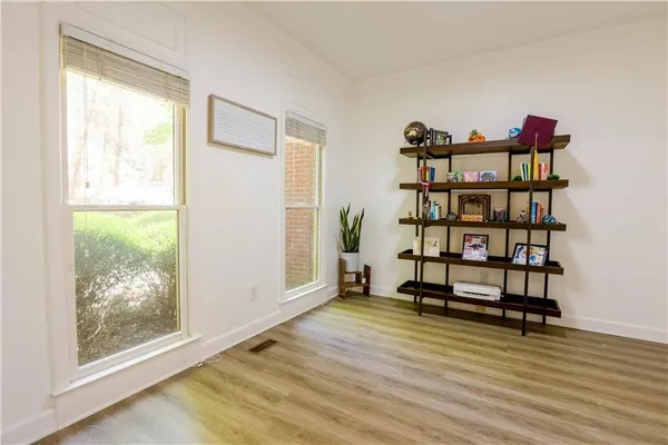 a view of a room with wooden floor and a window