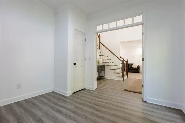 a view of entryway and hall with wooden floor
