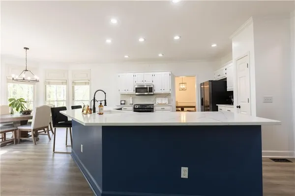 a kitchen with counter top space sink and center island