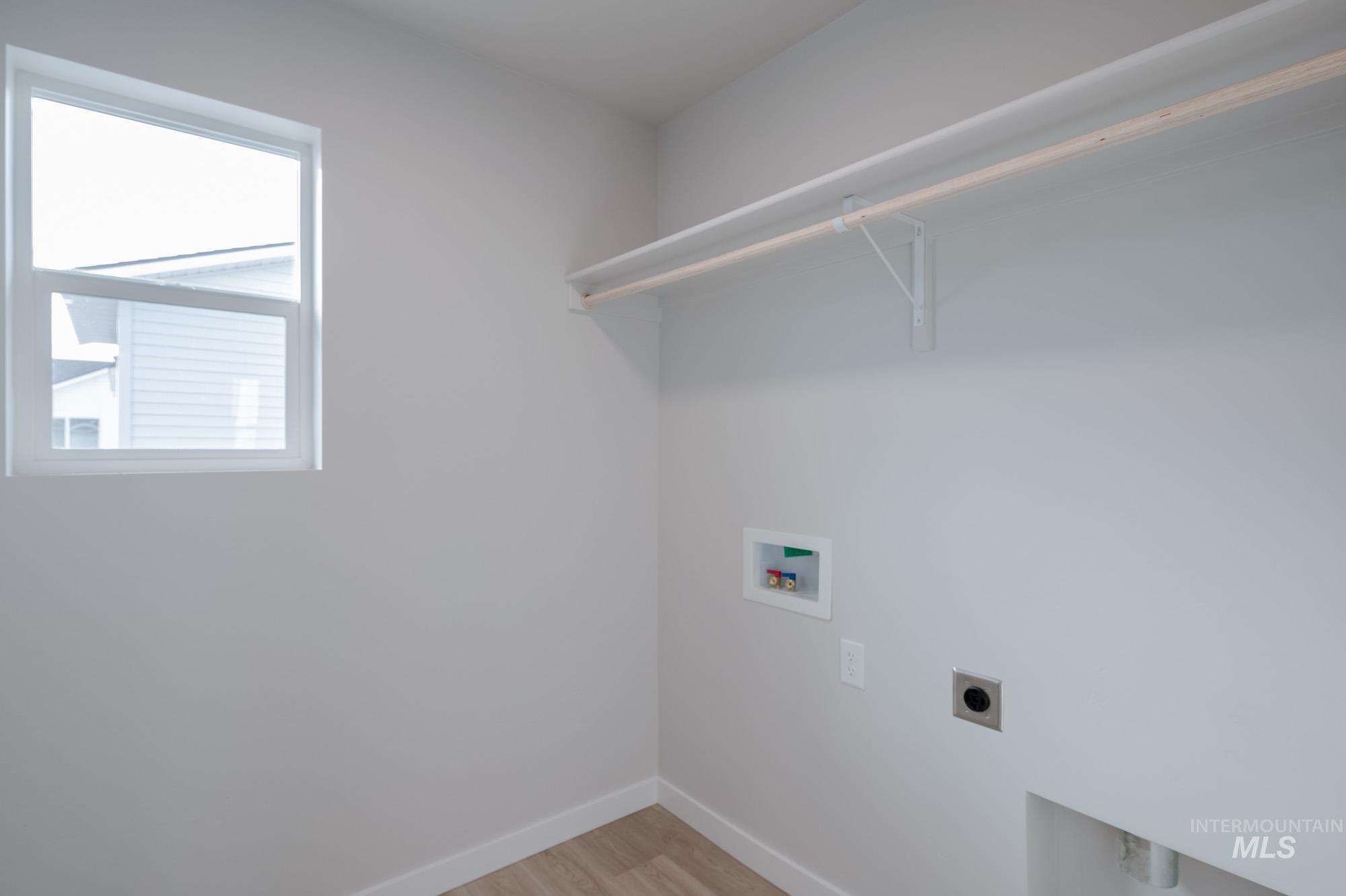 3089 South Maple Rnch Way Nampa, ID 83686 - Photo 19 of 22 Washroom featuring light wood finished floors, electric dryer hookup, and washer hookup