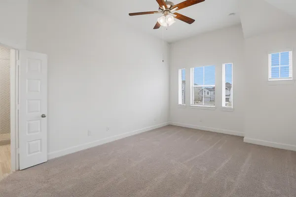 an empty room with closet and windows