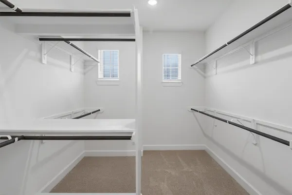 a view of a hallway with wooden floor and closet