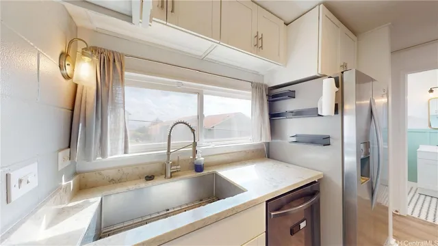 a kitchen with a refrigerator and a sink