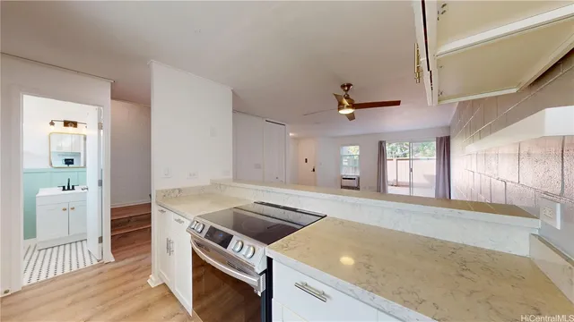 a kitchen that has a sink and a stove