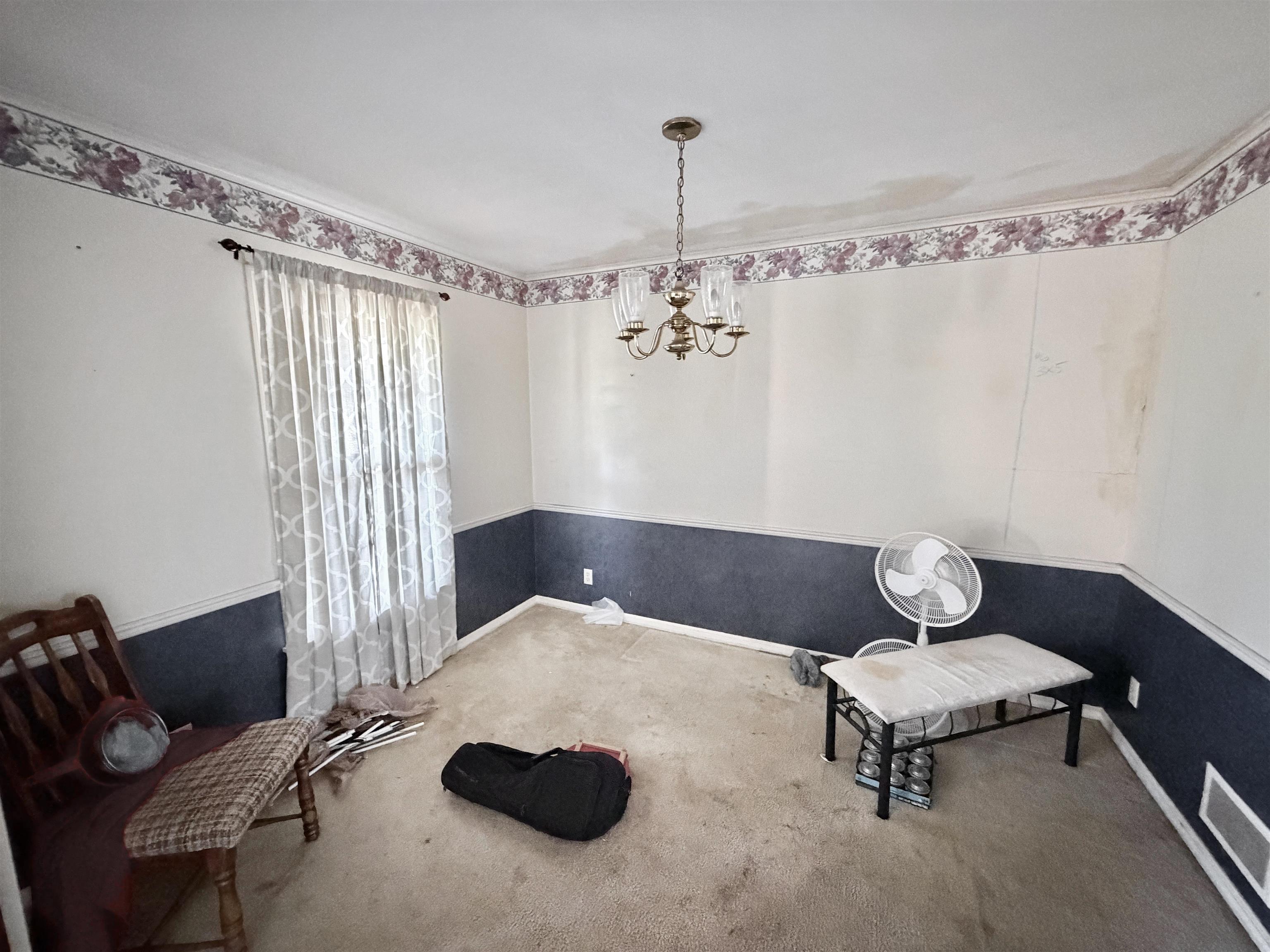 5536 Cottonwood Road Memphis, TN 38115 - Photo 27 of 28 Carpeted room with a ceiling-mounted chandelier light fixture and crown molding