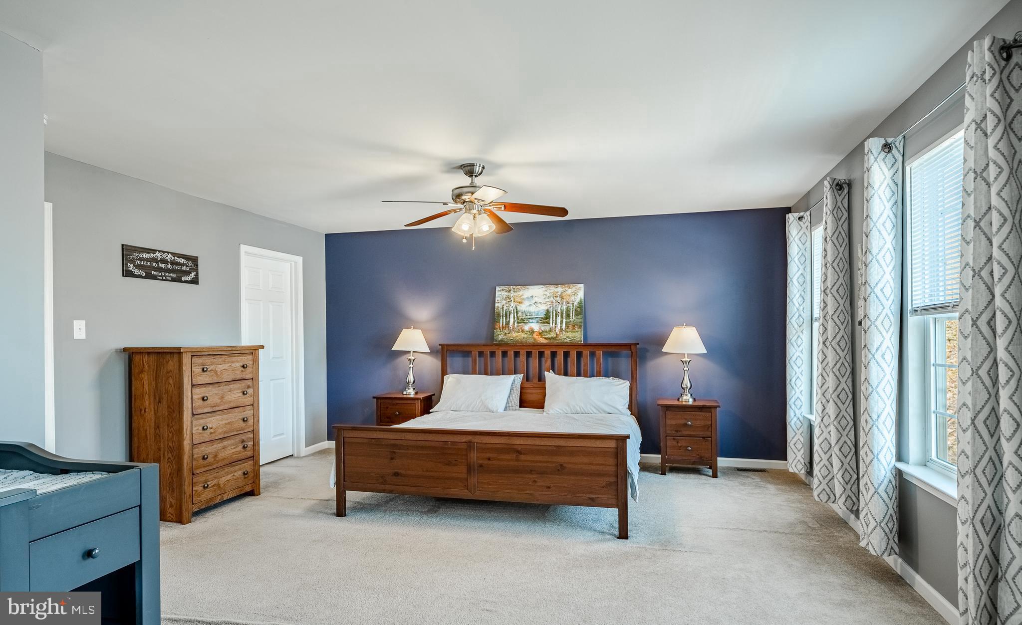 1345 Northumberland Road Coatesville, PA 19320 - Photo 26 of 52 a bedroom with a bed and a chandelier