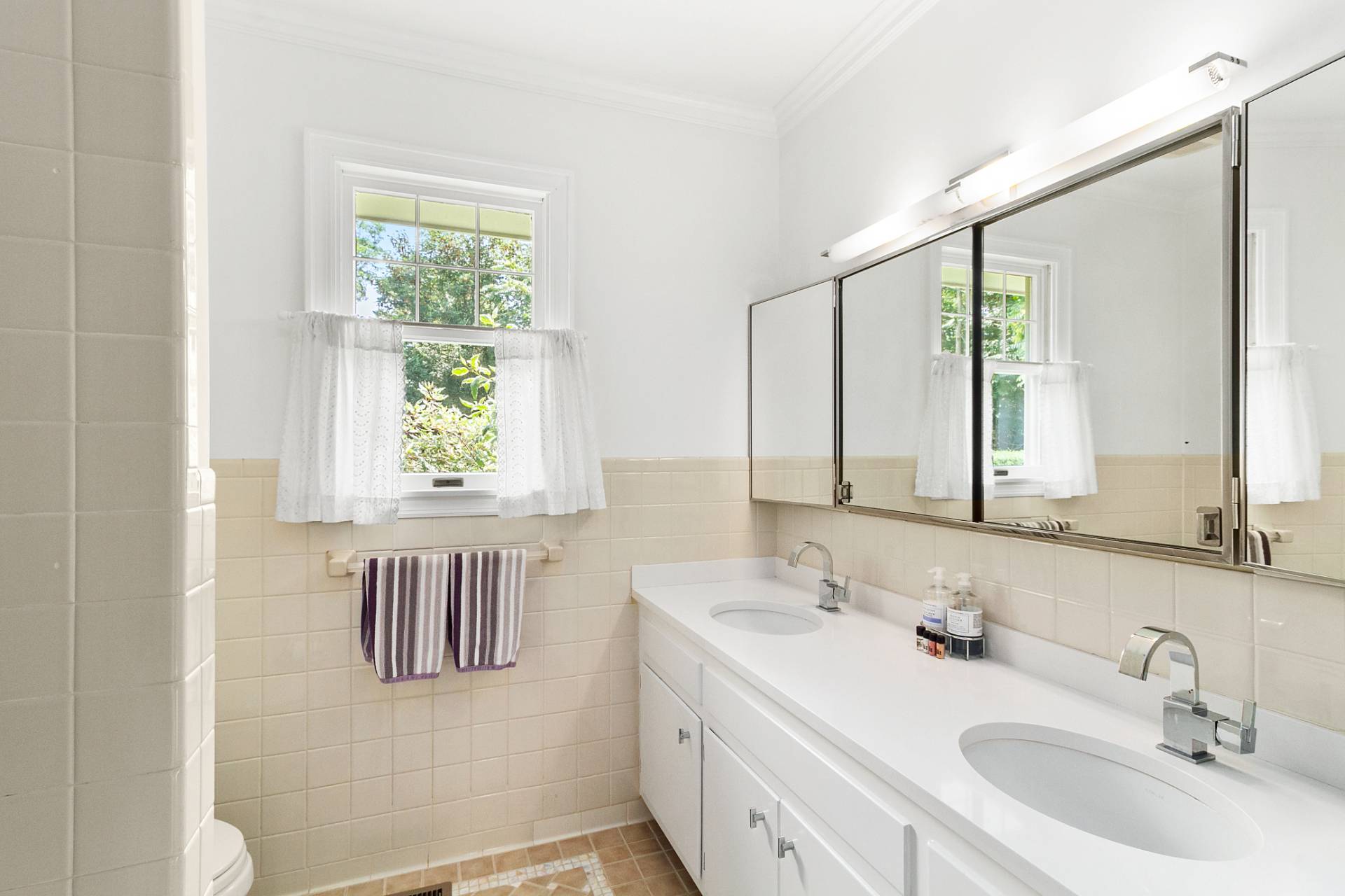 5 Coves End Lane Sag Harbor, NY 11963 - Photo 14 of 26 a bathroom with a double vanity sink and a mirror