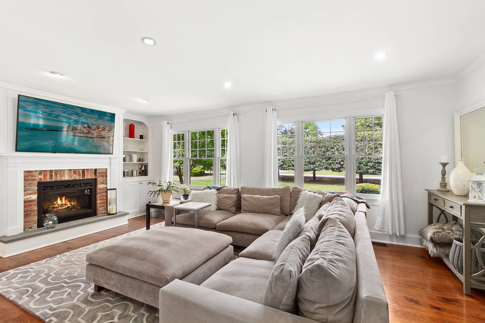 5 Coves End Lane Sag Harbor, NY 11963 - Photo 2 of 26 a living room with furniture large window and a fireplace