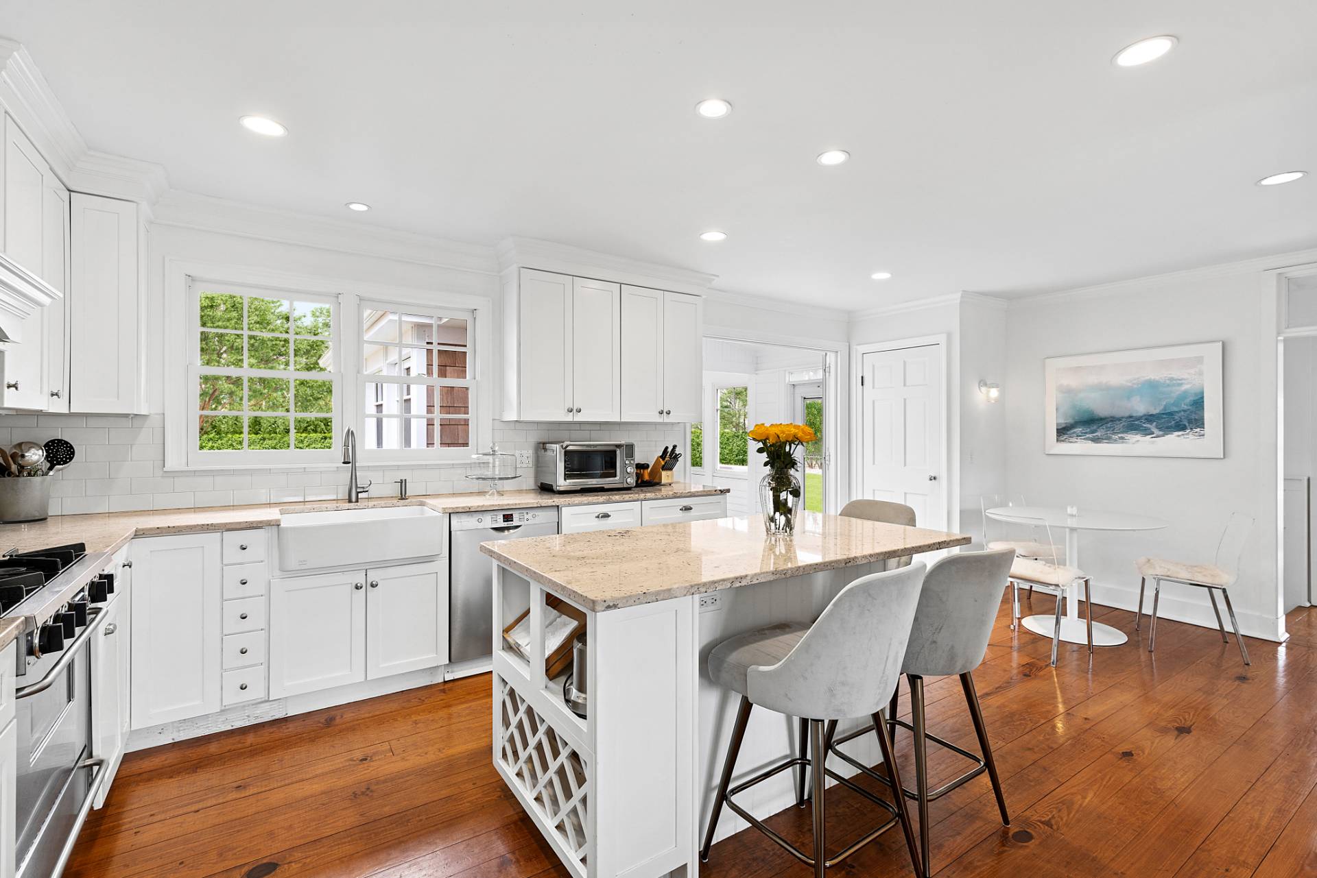 5 Coves End Lane Sag Harbor, NY 11963 - Photo 3 of 26 a large white kitchen with stainless steel appliances granite countertop a stove a sink a dining table and chairs