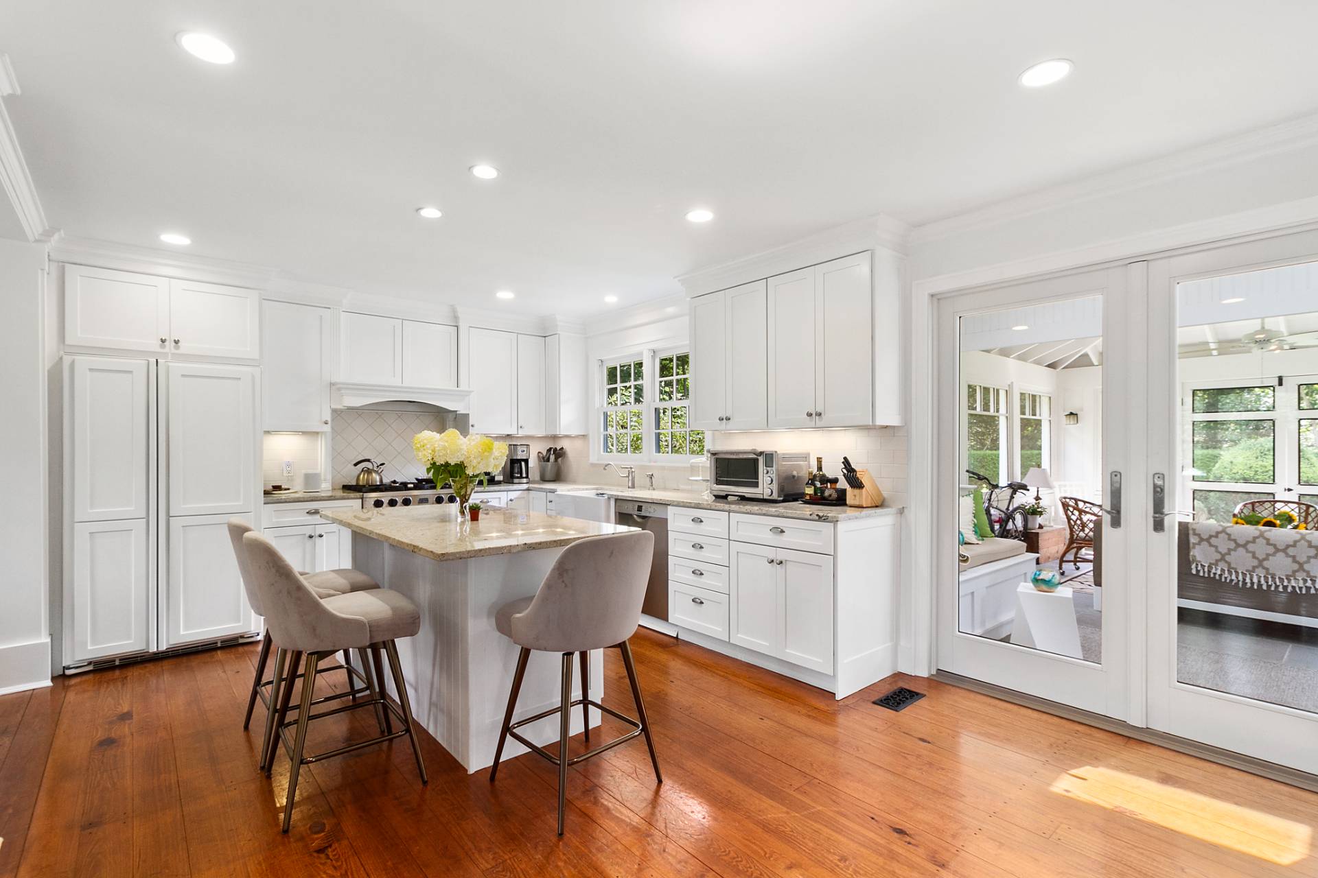 5 Coves End Lane Sag Harbor, NY 11963 - Photo 4 of 26 a kitchen with a table chairs refrigerator and cabinets