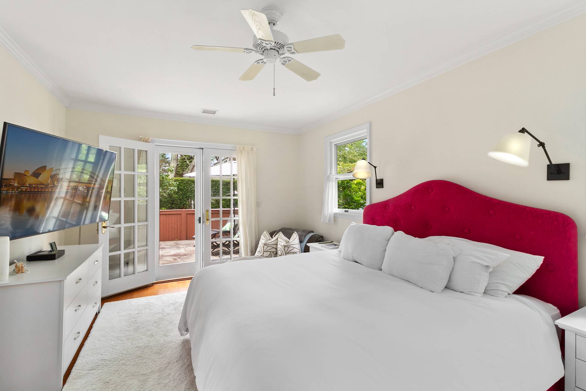 5 Coves End Lane Sag Harbor, NY 11963 - Photo 9 of 26 a bedroom with a large bed and a flat tv screen on dresser