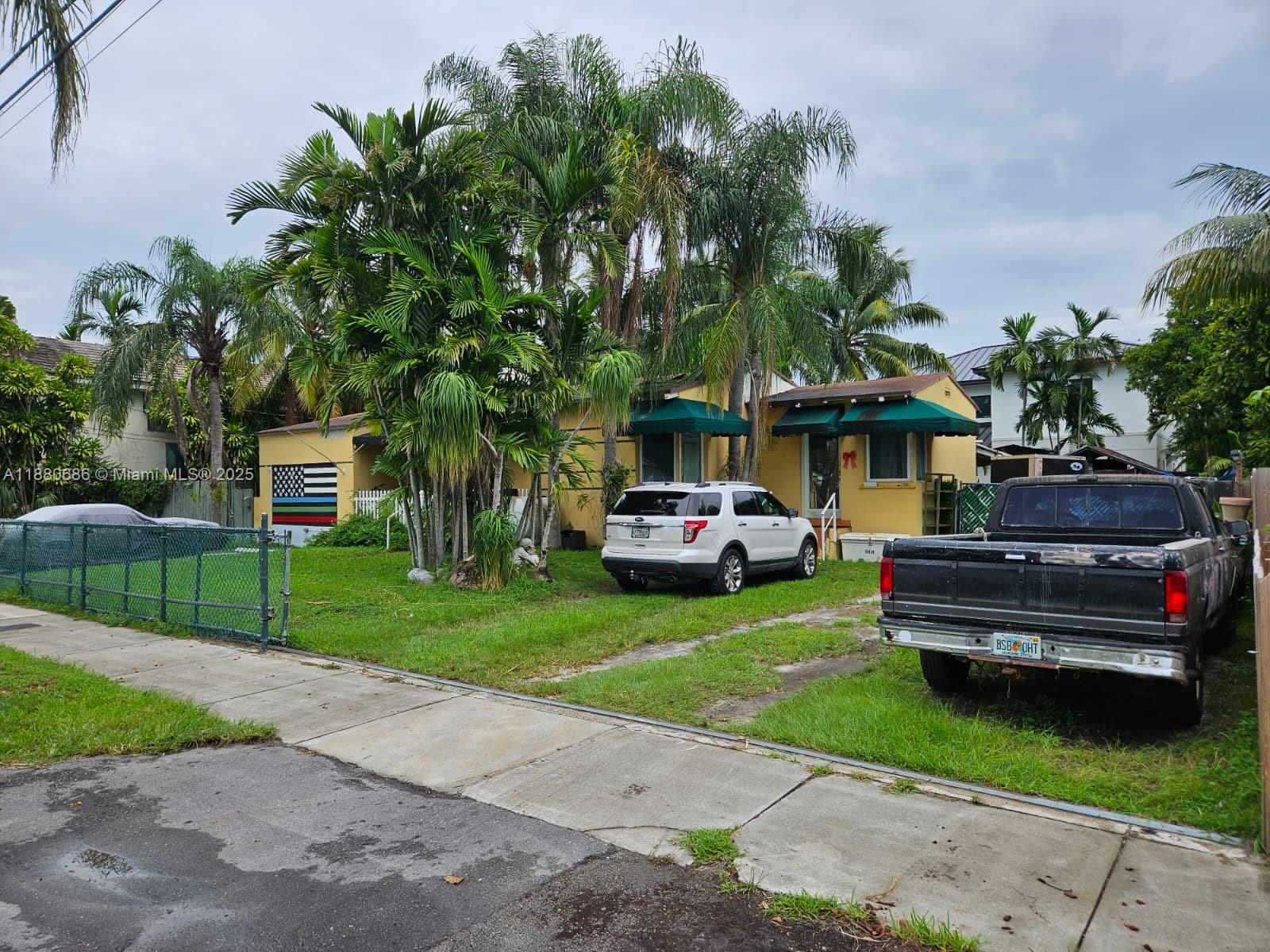 4021 Southwest 6th Street Miami, FL 33134 - Photo 13 of 14 a front view of a house with a garden and trees