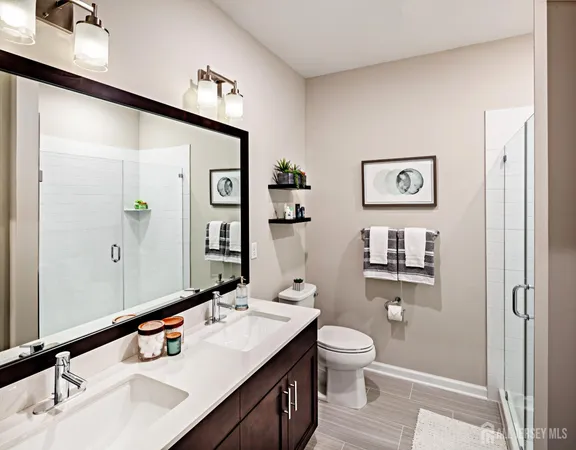 a bathroom with a double vanity sink and a mirror