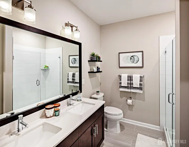 a bathroom with a double vanity sink and a mirror
