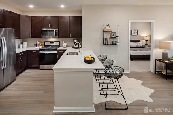 a kitchen with a refrigerator and a stove top oven