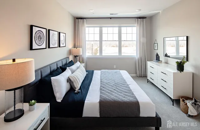 a bedroom with furniture and a window